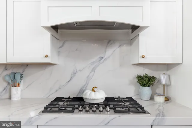 a kitchen with stainless steel appliances a sink window and cabinets