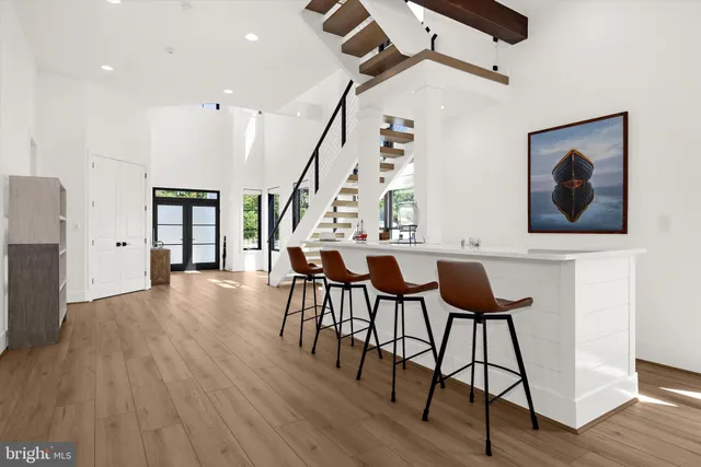 a living room with wooden floor and furniture