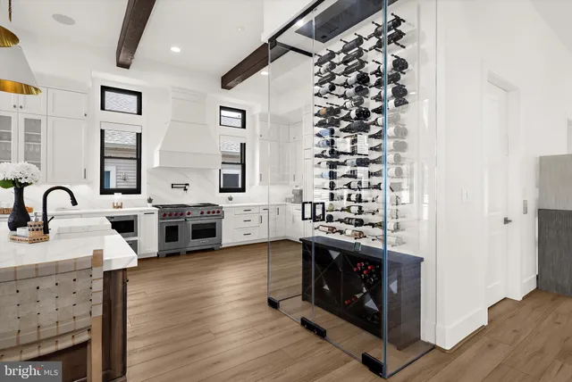 a kitchen with stainless steel appliances kitchen island granite countertop a sink a stove and white cabinets