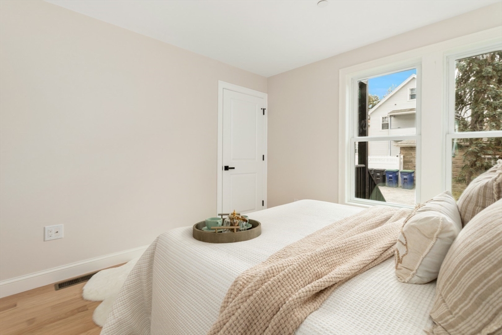 157 Boston Avenue, Unit 1 Somerville, MA 02144 - Photo 19 of 40 a bedroom with a bed and a window