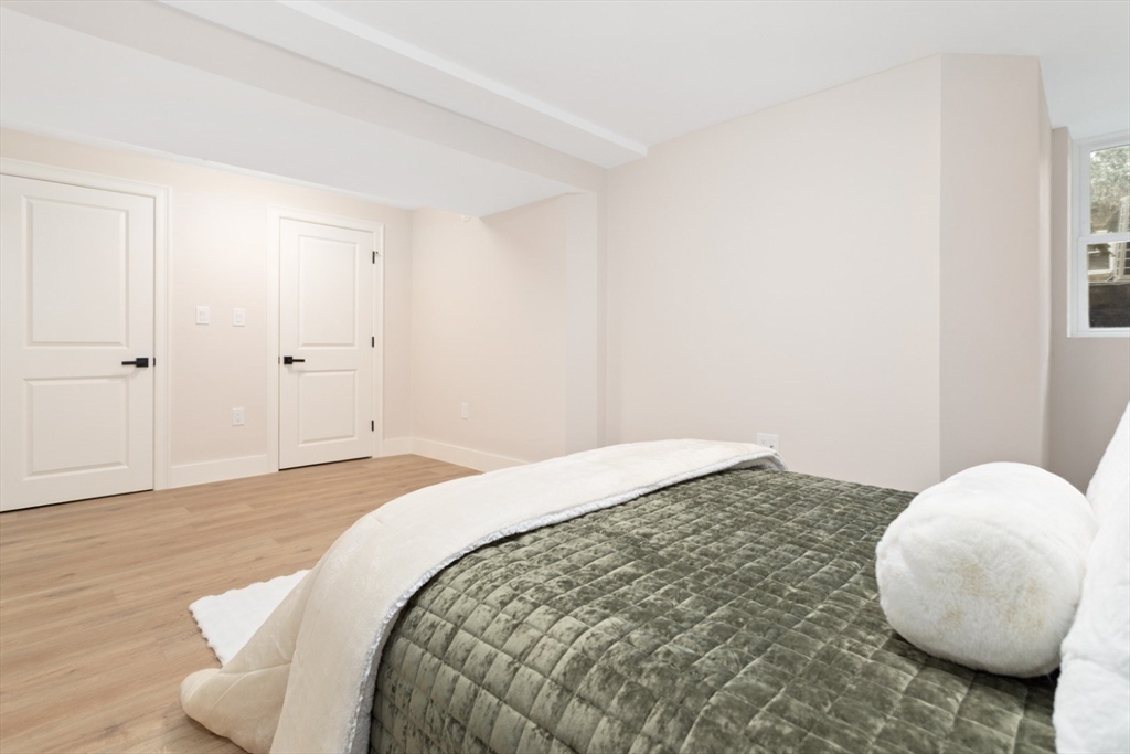 157 Boston Avenue, Unit 1 Somerville, MA 02144 - Photo 23 of 40 a bedroom with a bed and a chair