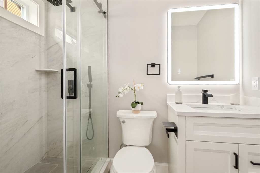 157 Boston Avenue, Unit 1 Somerville, MA 02144 - Photo 25 of 40 a bathroom with a toilet sink and shower