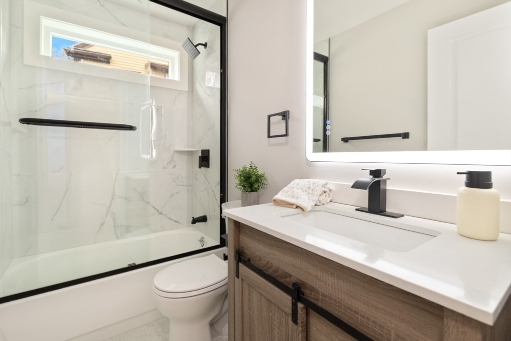 157 Boston Avenue, Unit 1 Somerville, MA 02144 - Photo 27 of 40 a bathroom with a sink a toilet and shower