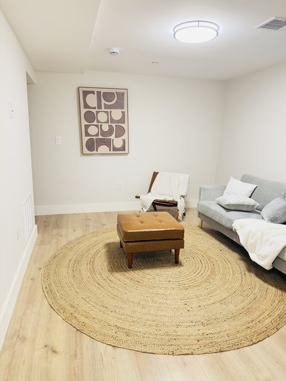 157 Boston Avenue, Unit 1 Somerville, MA 02144 - Photo 31 of 40 a bedroom with a bed and a couch