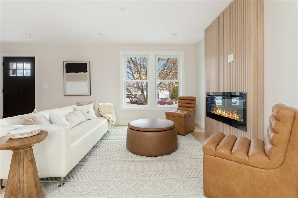 157 Boston Avenue, Unit 1 Somerville, MA 02144 - Photo 4 of 40 a living room with furniture and a fireplace