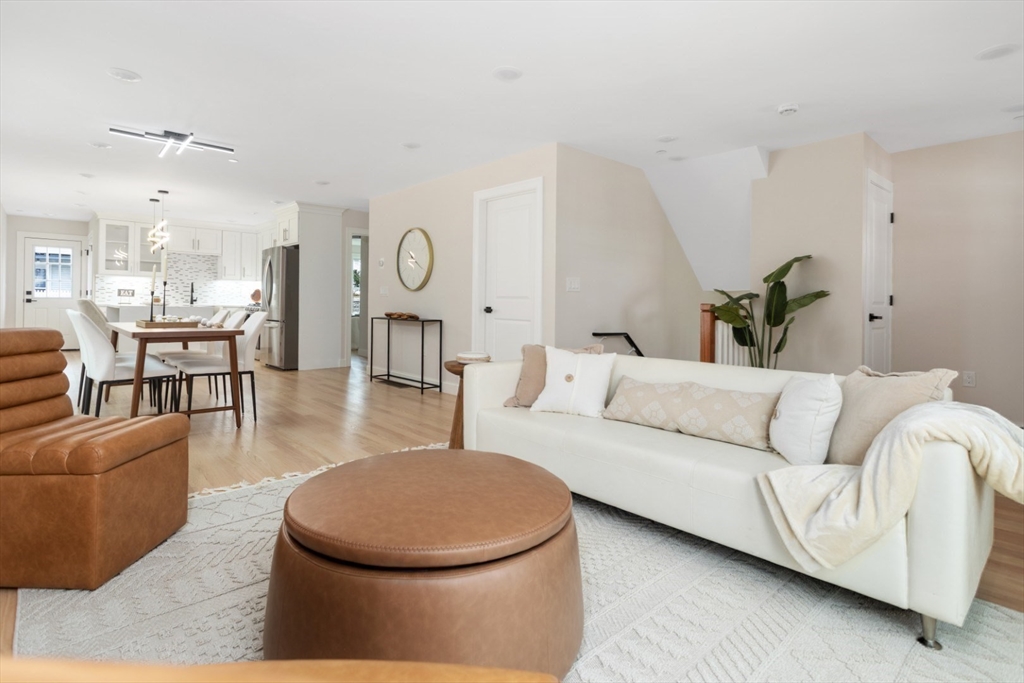 157 Boston Avenue, Unit 1 Somerville, MA 02144 - Photo 6 of 40 a living room with furniture a rug and white walls