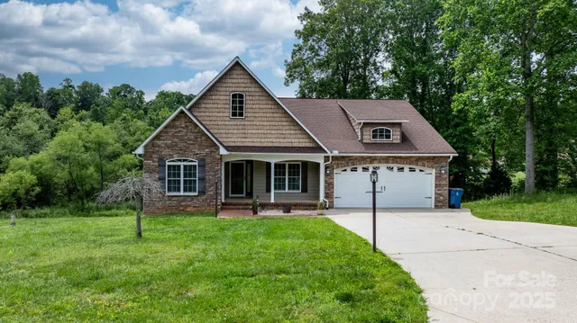 a front view of a house with a yard and trees