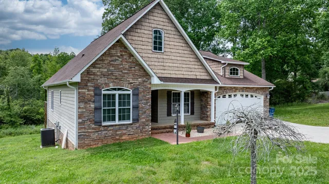 a view of a house with a yard patio and a garden