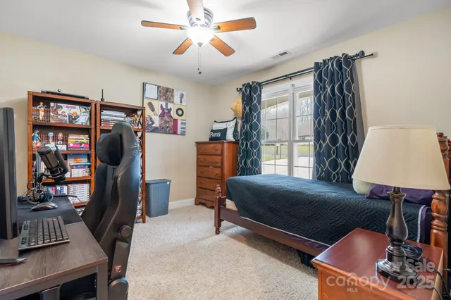 a bedroom with furniture and a window