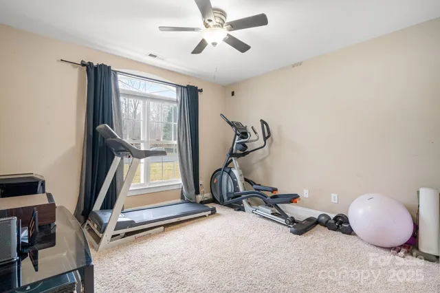 a room with gym equipment and windows