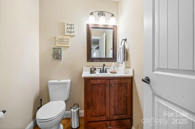 a bathroom with a toilet a sink and mirror