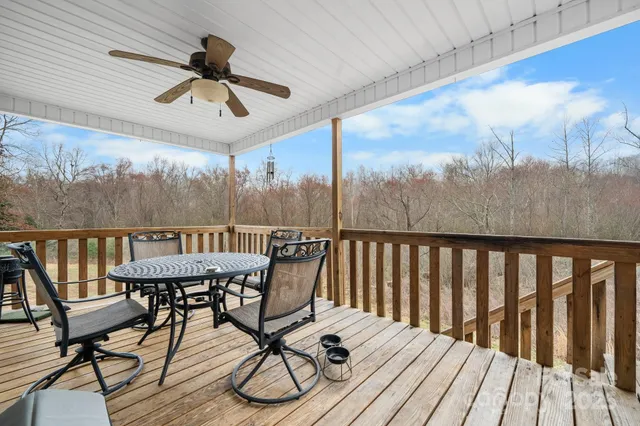 a view of a balcony with furniture and wooden floor