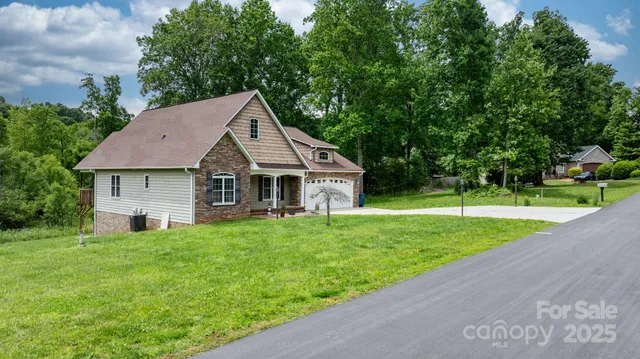 a front view of a house with a yard and trees