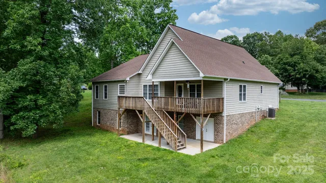 a view of a house with a yard and sitting area
