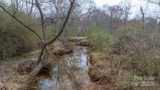 a view of a pool in a backyard