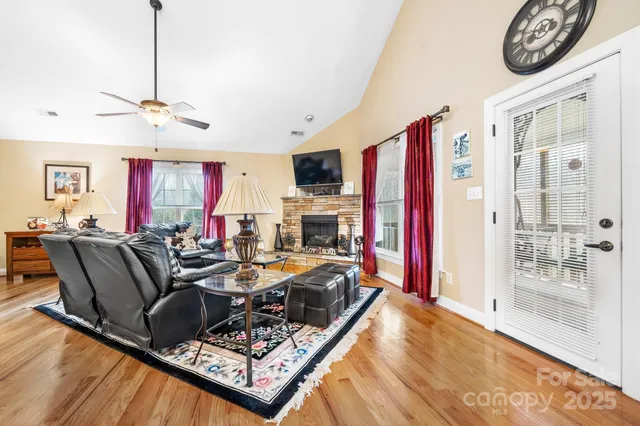a living room with furniture a fireplace and a flat screen tv
