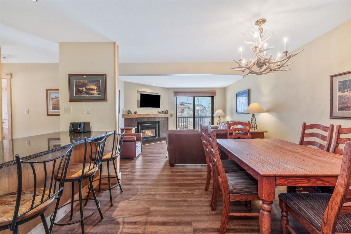a view of a dining room with furniture a chandelier and wooden floor