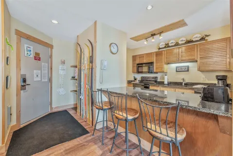 a kitchen with stainless steel appliances granite countertop a refrigerator and a stove top oven