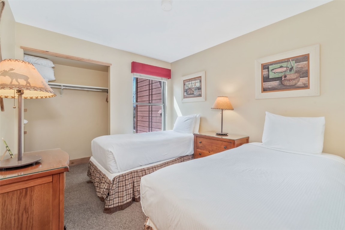 2015 Walton Creek Road, Unit 113 Steamboat Springs, CO 80487 - Photo 21 of 33 a bedroom with bed and a window