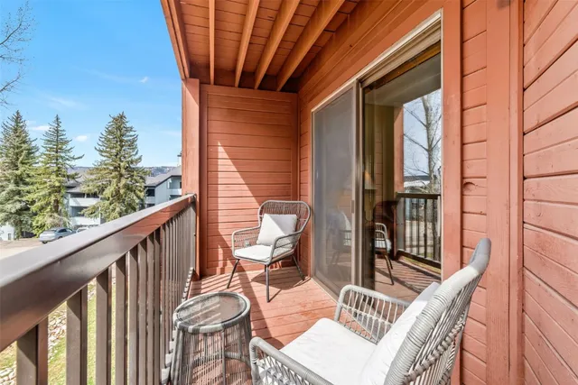 a balcony with table and chairs