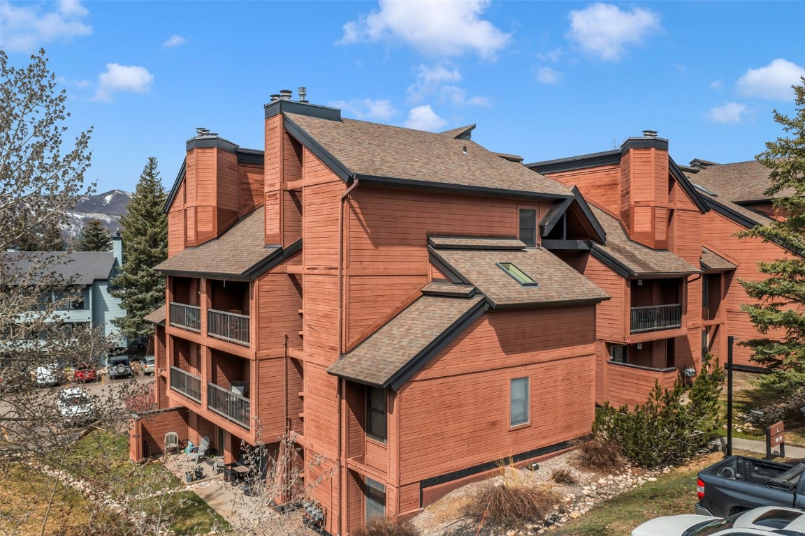 2015 Walton Creek Road, Unit 113 Steamboat Springs, CO 80487 - Photo 29 of 33 a front view of a house with a yard