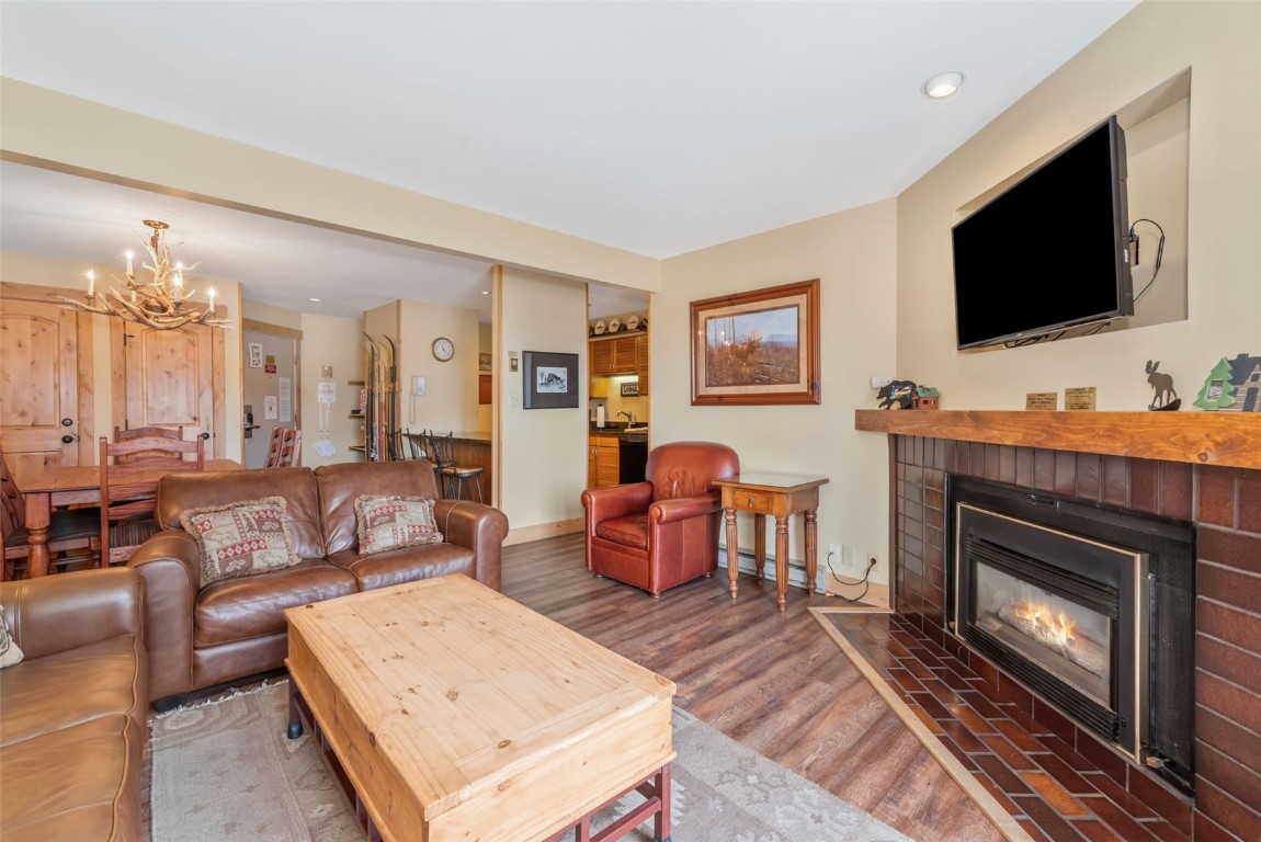 2015 Walton Creek Road, Unit 113 Steamboat Springs, CO 80487 - Photo 4 of 33 a living room with furniture a flat screen tv and a fireplace