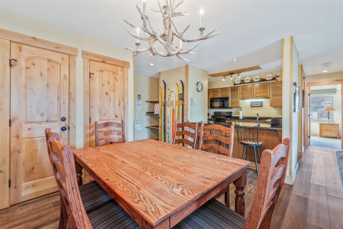 2015 Walton Creek Road, Unit 113 Steamboat Springs, CO 80487 - Photo 8 of 33 a dining room with wooden floor and large window