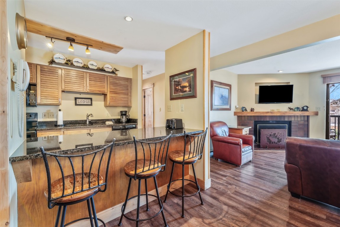 2015 Walton Creek Road, Unit 113 Steamboat Springs, CO 80487 - Photo 10 of 33 a view of a dining room with furniture window and wooden floor