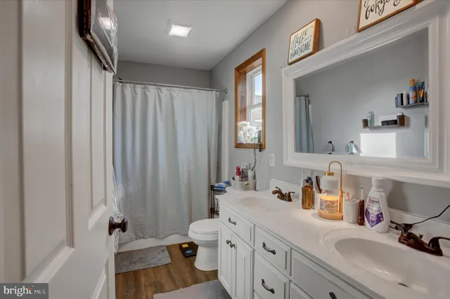 a bathroom with a sink a mirror and a shower