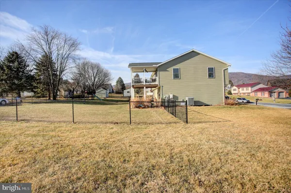 a view of a yard with wooden fence