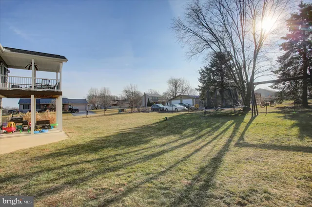 a view of yard with swimming pool and seating