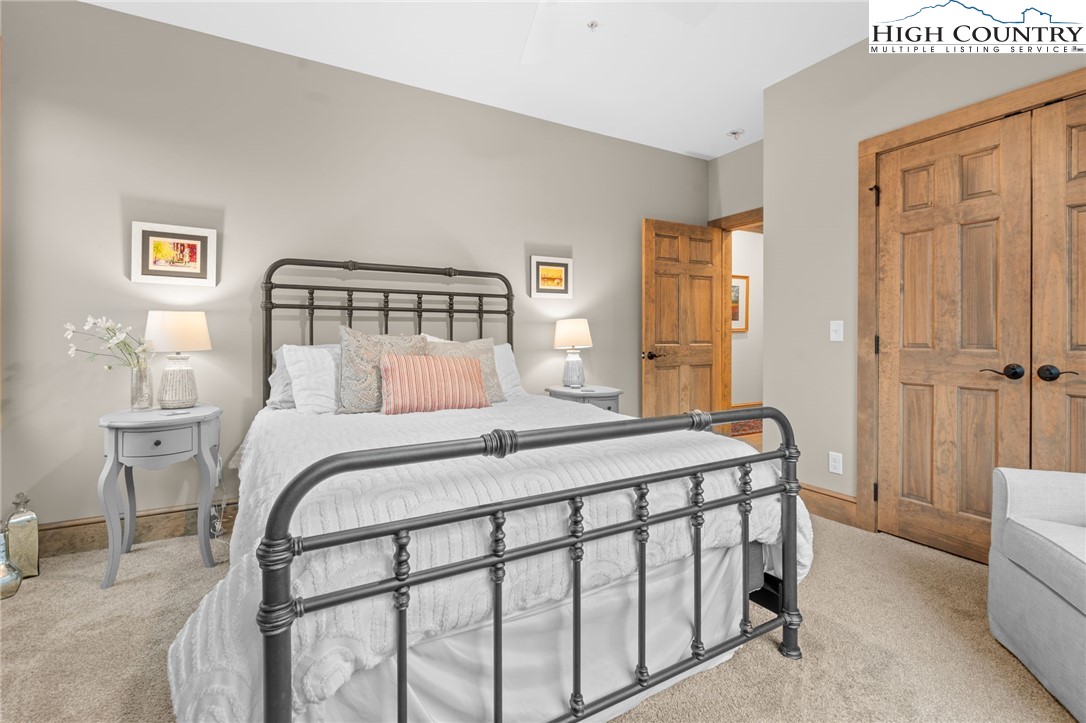 396 Summit View Parkway, Unit S1221 Boone, NC 28607 - Photo 18 of 37 a bedroom with a bed and a table