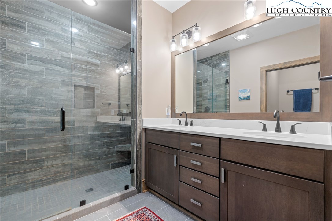 396 Summit View Parkway, Unit S1221 Boone, NC 28607 - Photo 28 of 37 a bathroom with a double vanity sink mirror and shower