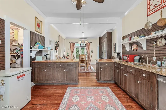 a kitchen with stainless steel appliances granite countertop a sink and cabinets