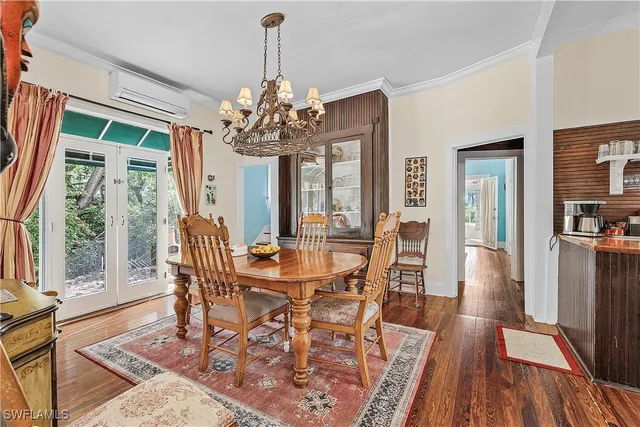 a view of a dining room with furniture wooden floor and chandelier