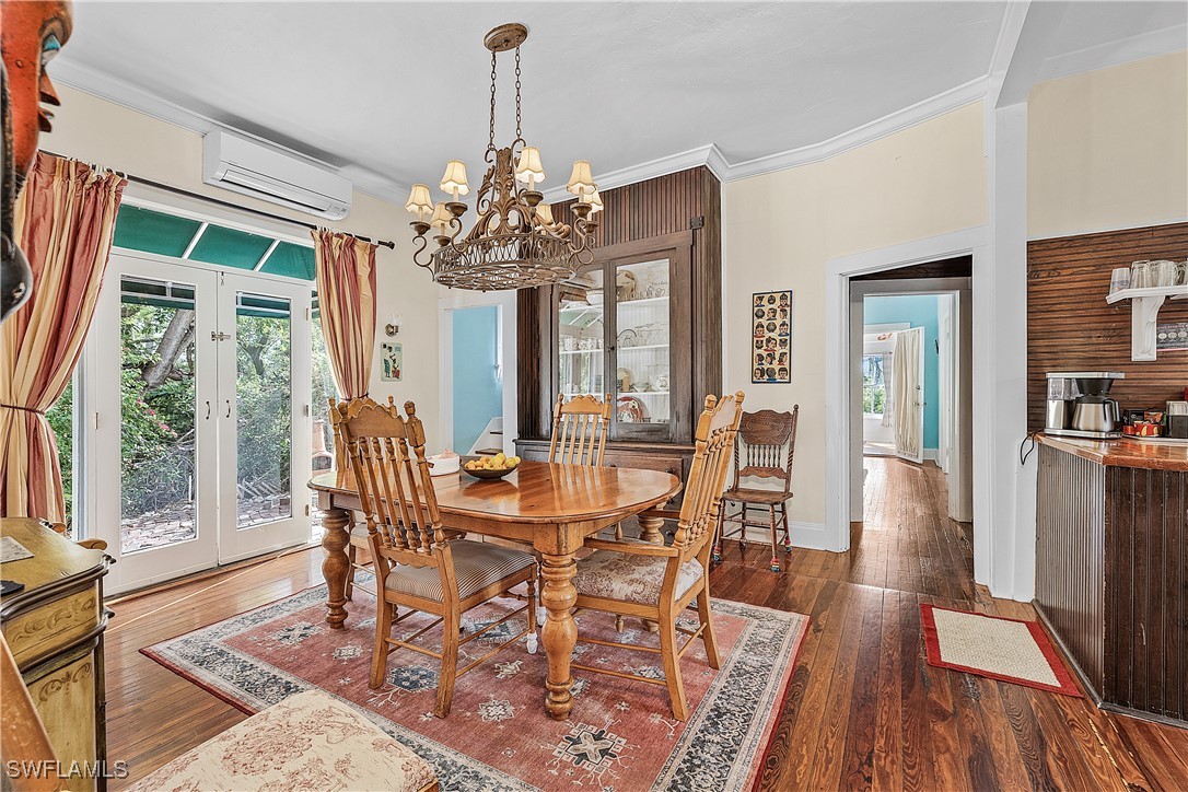 13841-13845 Robert Road Bokeelia, FL 33922 - Photo 16 of 50 a view of a dining room with furniture wooden floor and chandelier