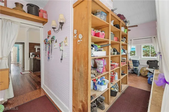 a view of a room with lots of stuff and hardwood floor