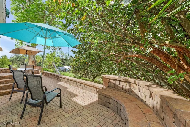 a view of an outdoor sitting area with furniture and an umbrella