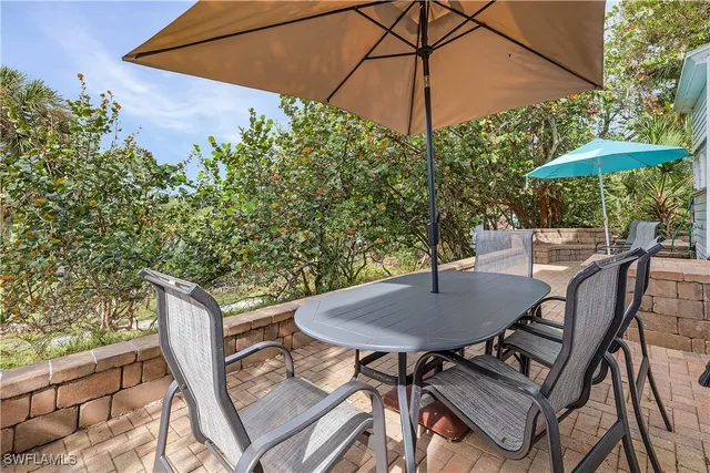 a view of backyard of house with yard and outdoor seating