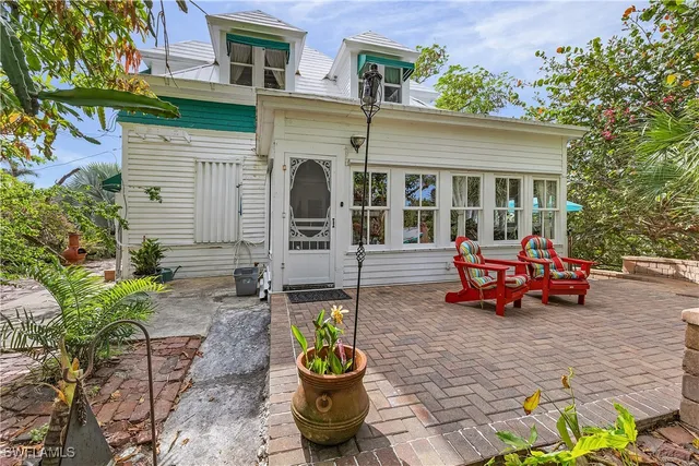 a backyard of a house with yard and outdoor seating