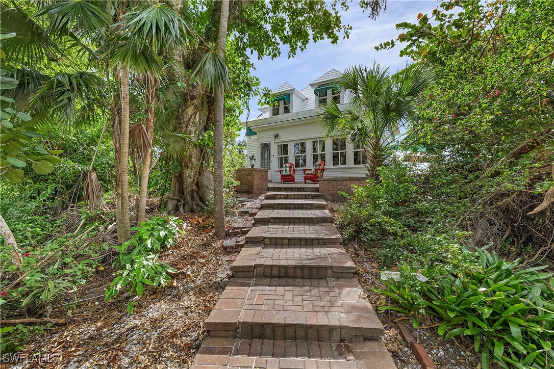13841-13845 Robert Road Bokeelia, FL 33922 - Photo 32 of 50 a front view of a house with a yard