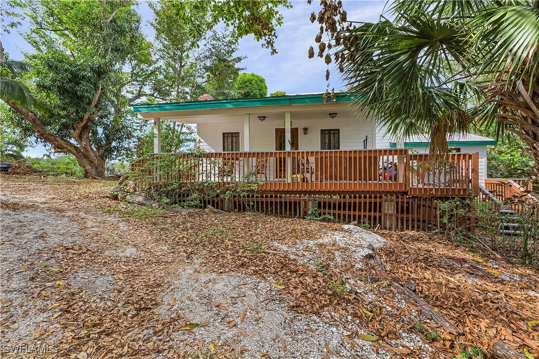 13841-13845 Robert Road Bokeelia, FL 33922 - Photo 33 of 50 front view of a house with a yard