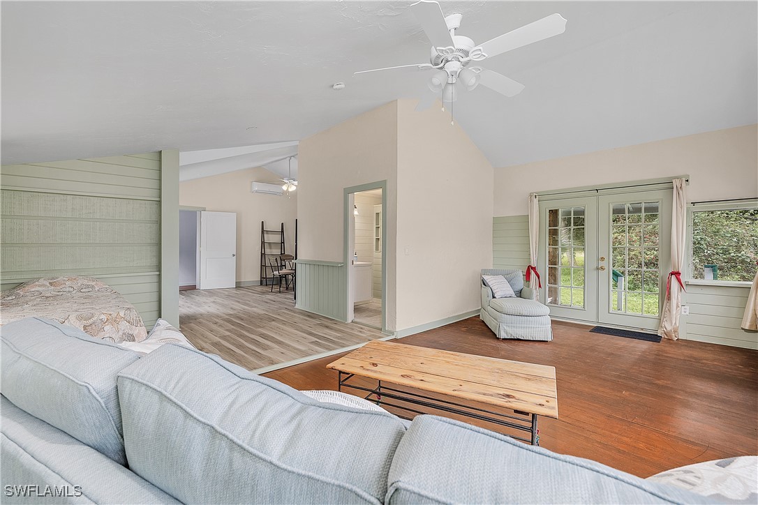 13841-13845 Robert Road Bokeelia, FL 33922 - Photo 48 of 50 a bedroom with a bed and wooden floor