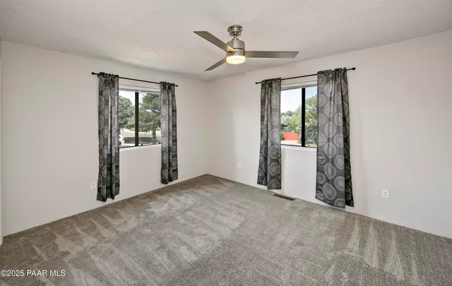 an empty room with windows and closet