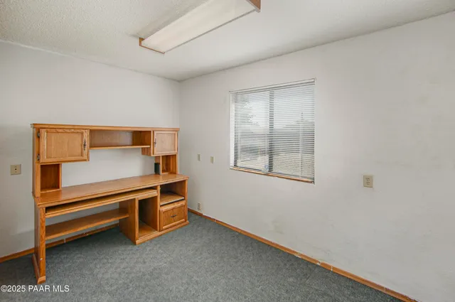 a bedroom with bed and window