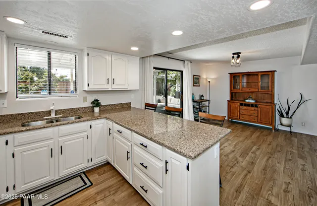 a kitchen with stainless steel appliances granite countertop a stove and a sink