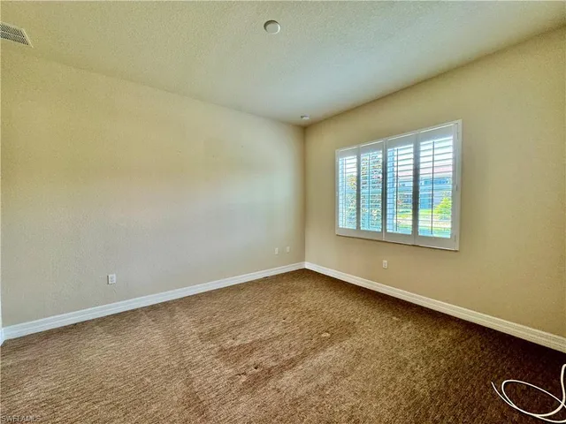 an empty room with closet and wooden floor