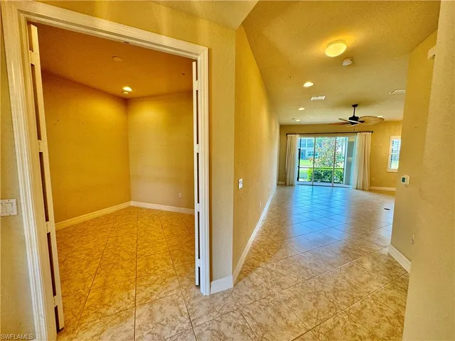 a view of hallway with livingroom and wooden floor