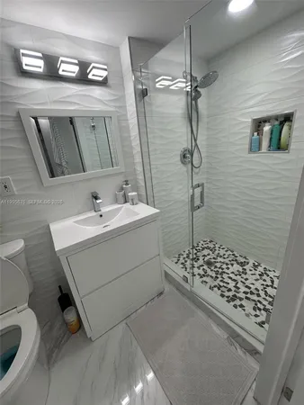 a bathroom with a sink toilet and shower