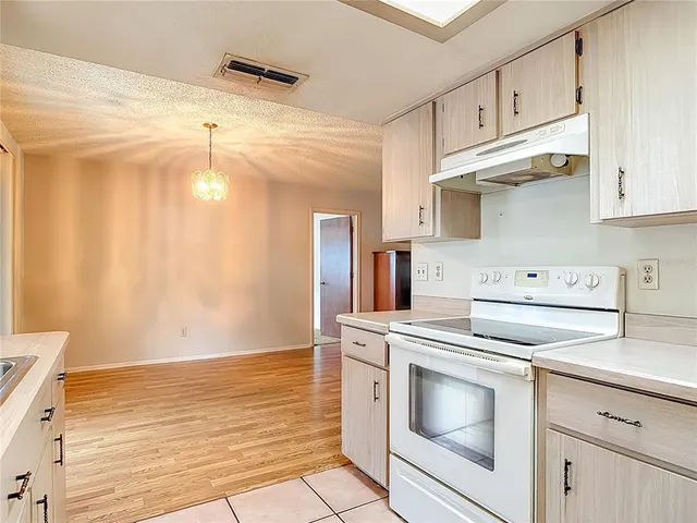 a kitchen with cabinets and appliances